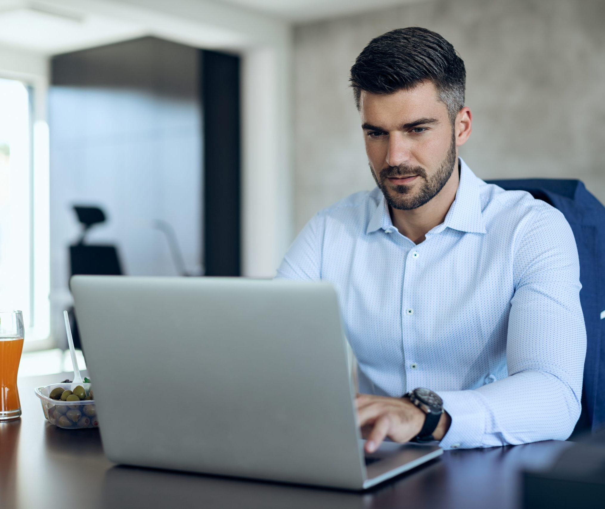 Male entrepreneur using computer while working in the office.